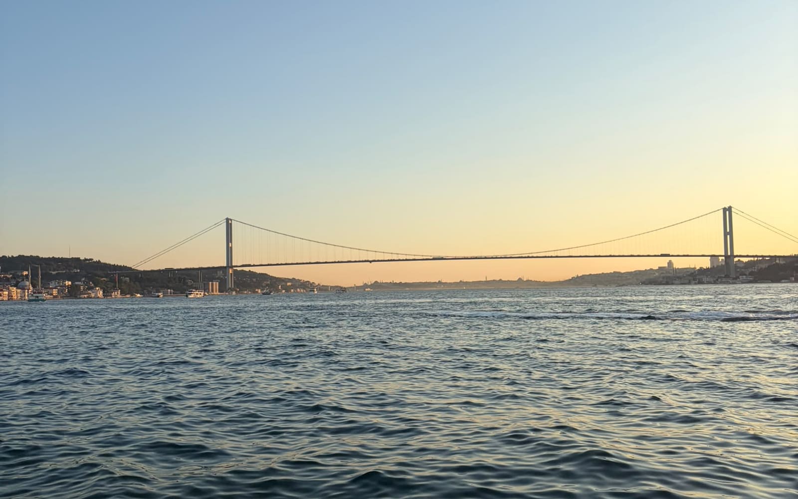 The Bosphorus Bridge in Istanbul at sunset, seen from the water